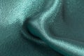 Silk background, texture of green shiny fabric