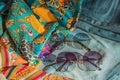 Silk clothes abstract texture and hippie sun glasses