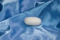 Silk cocoon on blue silk