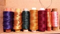 Silk and cotton threads for sewing and embroidery. Spools with multi-colored threads. Royalty Free Stock Photo