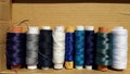 Silk and cotton threads for sewing and embroidery. Spools with multi-colored threads. Royalty Free Stock Photo