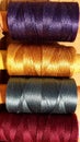 Silk and cotton threads for sewing and embroidery. Spools with multi-colored threads. Royalty Free Stock Photo