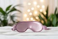 Silk eye mask for sleep, bed, plants and light bokeh Royalty Free Stock Photo