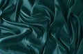 Silk fabric, abstract wavy green satin fabric background.