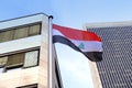 Silk national flag of Algeria on facade building of Consulate General of iraq in Frankfurt, concept of emigration, international