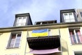 Silk national Ukrainian flag on facade building, on balcony in Frankfurt, pacifist banner, concept of emigration, international