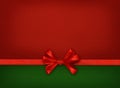 Silk ribbon and a bow on red and green paper Royalty Free Stock Photo