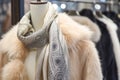 silk scarf on mannequin with a faux fur coat in a luxe display