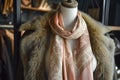 silk scarf on mannequin with a faux fur coat in a luxe display