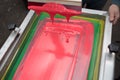 Silk screen printing. Serigraphy. Color paints and fabric. Plastisol paint and squeegee