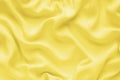 Silk texture, abstract background luxury yellow fabric with wavy folds Royalty Free Stock Photo