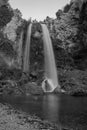 Silk water. Black and white waterfalls. Waterfall in forest landscape long exposure flowing through trees and over rocks in black