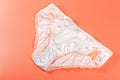 Silk white womens panties on a peach background