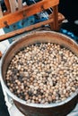 Silkworm cocoons in hot water in cauldron