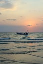 Sillhouette of fishing long tail boat on sunset