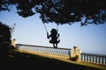 Girl swinging in her home garden