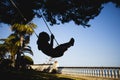 Girl swinging in her home garden