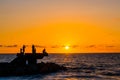 Sillhouette of people in the beach during sunset