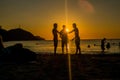 Sillhouette of three fiends enjoying in the beach