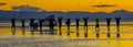 Sillouette of tourists posing as a groun on Bolivian Salt Flats in Bolivia