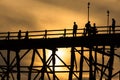 Silluate man on wooden bridge during at sunset Royalty Free Stock Photo