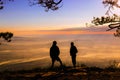 Silluate tow man raise hand up and standing during sunset on top Royalty Free Stock Photo