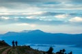 Silluettes of two men and a dog enjoying the great view from mountain Royalty Free Stock Photo