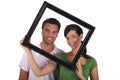 Silly couple with picture frame Royalty Free Stock Photo