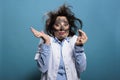 Silly and crazy biochemist looking at microscopic sample after chemical explosion. Royalty Free Stock Photo