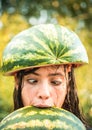 Silly girl makes funny face biting while watermelon. Sale for entire autumn collection, incredible discounts, wonderful Royalty Free Stock Photo