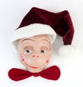 Monkey face with Santa hat and red bow tie. Royalty Free Stock Photo