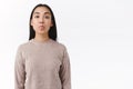 Silly and playful cute asian woman in winter sweater acting childish and funny, showing tongue, pouting and look camera