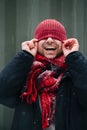 Silly portrait of a positive middle age man with winter hat over his eyes Royalty Free Stock Photo