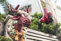 A silly reindeer bust and Santa statue placed on the front gate of a house. Cute outdoor Christmas decorations