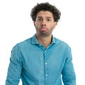 silly young man with curly hair making a cute face with big eyes Royalty Free Stock Photo