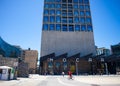 Silo district near the Waterfront. Zeitz Museum of Contemporary Art Africa, man on bicycle and people in face masks walking by. Royalty Free Stock Photo