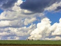 Silo and green corn field with many clouds in sky Royalty Free Stock Photo