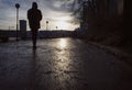 Silhouette of man walking on a damp street a gloomy day in late autumn/winter, Royalty Free Stock Photo