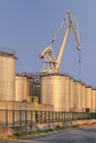 Silos and crane at an oil refinery, Port of Antwerp, Belgium. Royalty Free Stock Photo