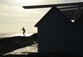 Silouette of a boy jumping from pierce in front of brightly lighted sea Royalty Free Stock Photo