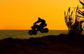 Silouette of quad bike jumping Royalty Free Stock Photo