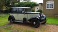 Vintage 1933 Austin 12-4 Harley parked by cottage in sunshine.