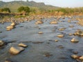 Silting of the river flow so you can see the rock