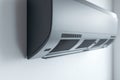 Silver Air Conditioner Unit Mounted on White Wall with Subtle Shadows Home Climate Control Device Modern Design for Cooling and Royalty Free Stock Photo