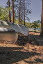 Silver aluminum canoes at a mountain lake in Southern California with pine trees