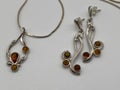 Silver and amber gem earrings with two dangling jewels Royalty Free Stock Photo