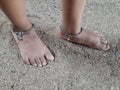 Silver anklets on both feet of a small girl