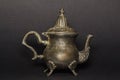 Silver antique kettle on a black background. Chaika made of silver. An antique teapot for tea.