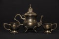 Silver antique teapot on a black background. A beautiful antique silver teapot. The kettle is silver. Royalty Free Stock Photo