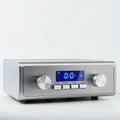 A silver audio amplifier with a sleek, modern design. The front panel features a blue Royalty Free Stock Photo